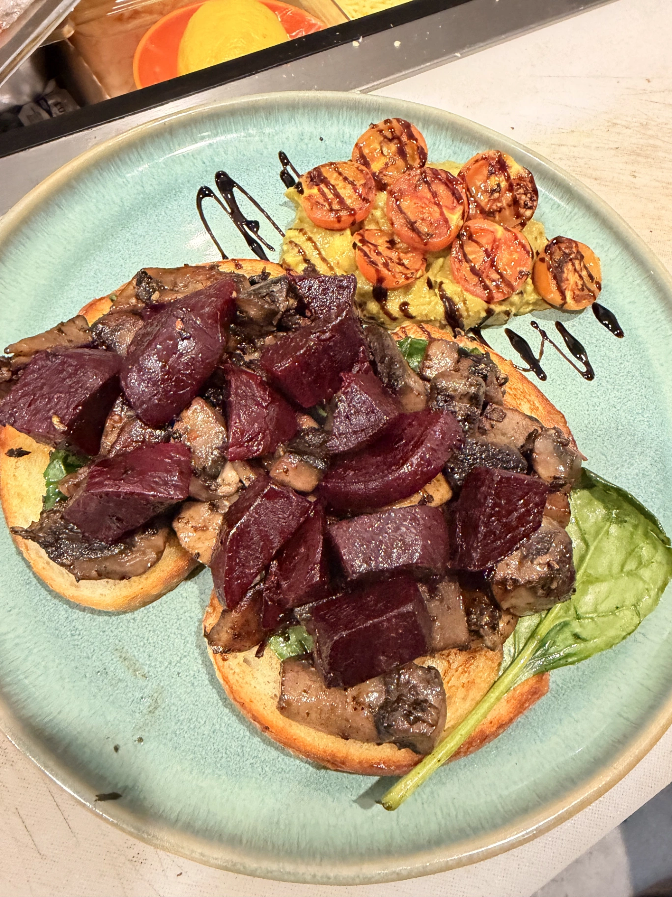 Beetroot and mushroom toast with smashed avocado and roasted tomatoes